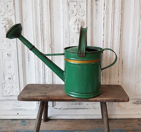 Old green painted water jug