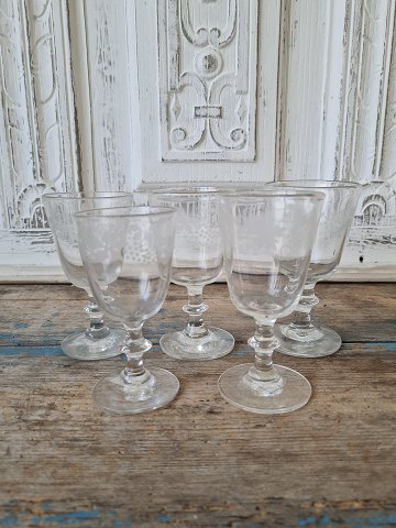 Set of 5 antique wine glasses decorated with bunches of grapes and vine leaves