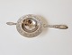 Empire tea strainer in silver