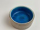 Italian ceramic bowl by Guido Gambone. Clear blue inside. Beige with brown 
stripes on the outside. Italy in the middle of the 20th century