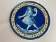 French faience plate / wall plaque with motif of blue girl with long braids in 
relief. The girl dances and plays music with castanets and tambourine, first 
half of the 20th century