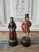 Just Andersen figure in local costumes made of painted metal mounted on a wooden 
base. Amager girl and man from Røsnæs