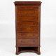 Danish Cabinetmaker
Tall chest of drawers in mahogany with seven drawers and central locking. 
Finished with detailed carvings and beautiful details.
1 pc. in stock
Good, used condition
