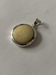 Silver pendant with inlaid bone.