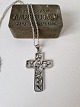 Silver necklace with large silver cross decorated with flowers by Eiler & Marløe
